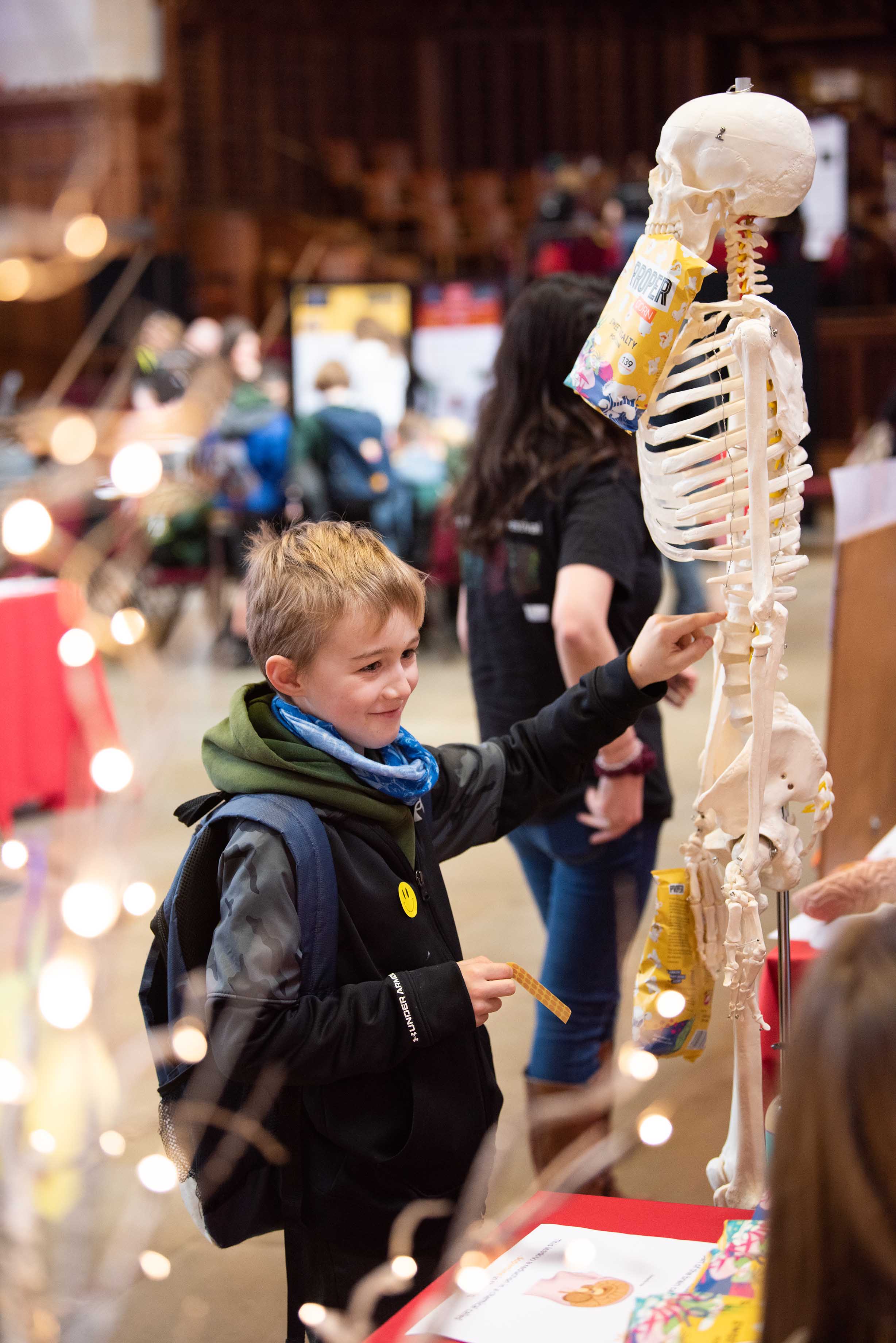 Pupil standing next to a human skeleton